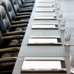 Boardroom table set for meetings such as an Annual General Meeting